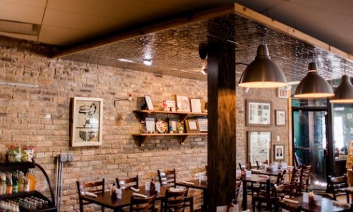 restaurant interior with red brick walls and large wood support columns