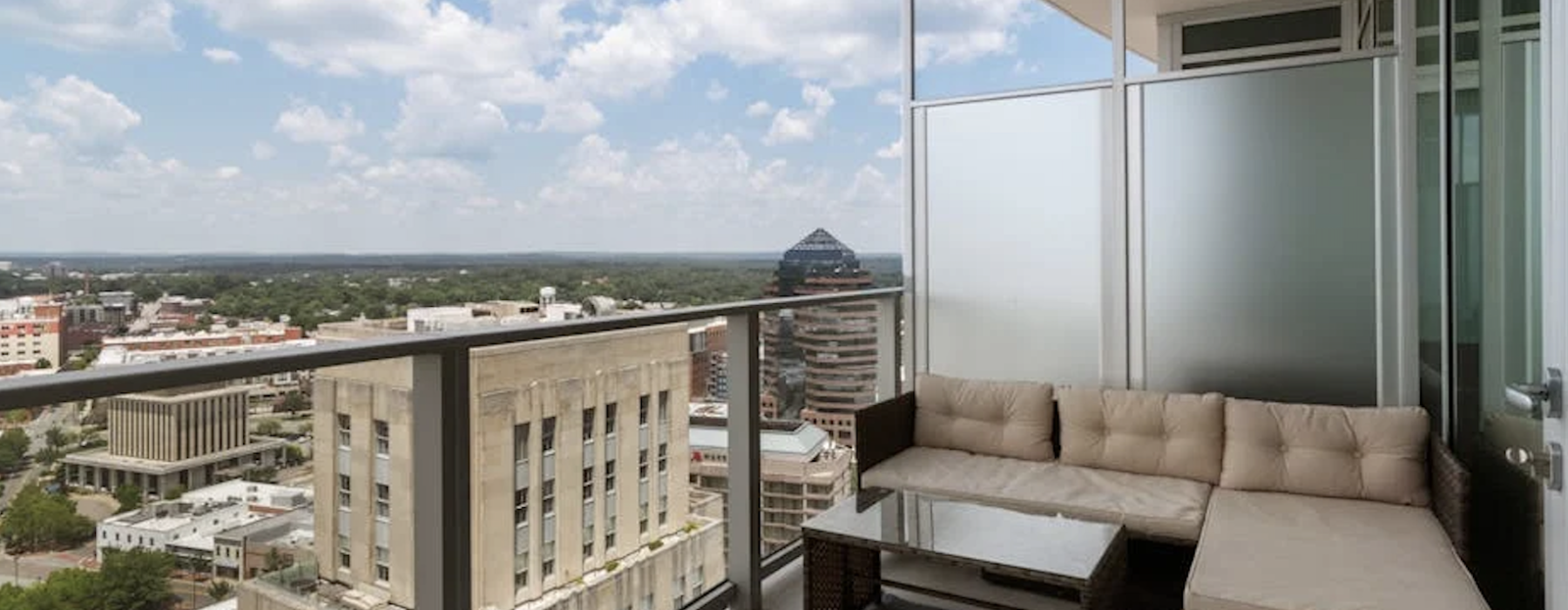 private apartment balcony with modern furniture overlooking city skyline at dusk - apartments with private balcony